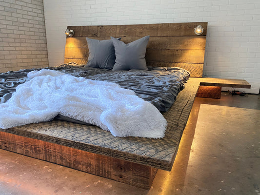 Reclaimed wood platform bed base with nighstands and elongated angled solid wood headboard with lighting